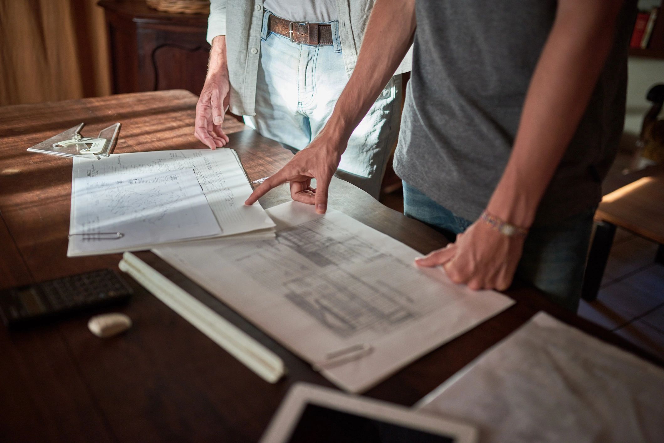 Person reviewing plans at a desk